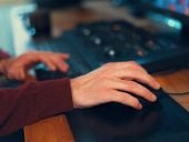 Video editor hands adjusting color or sound on working console machine