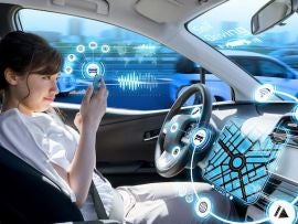 young woman using a smart phone in a autonomous car. driverless car. self driving vehicle. heads up display. automotive technology.
