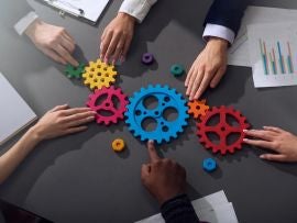 Business team connect pieces of gears. Teamwork, partnership and integration concept