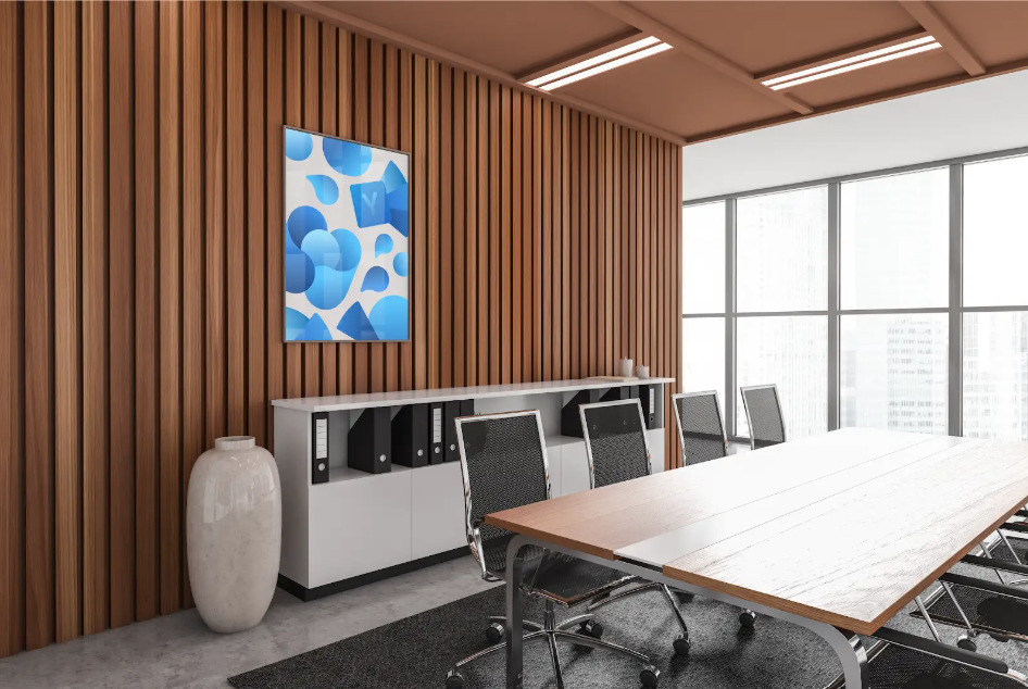 A conference room with a shelf stocked with files and a table with modern black office chairs. A wooden accent wall also features the Microsoft Viva branding in a blue painting.