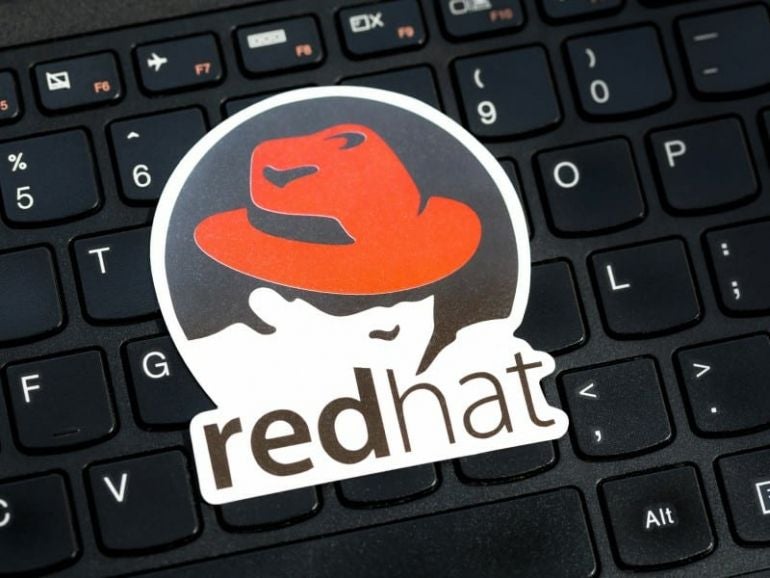 RHEL OS, Red Hat Enterprise Linux operating system commercial market distribution logo, symbol, sticker on a laptop keyboard, object closeup