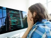 Stressed computer programmer in front of computer