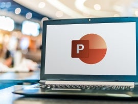 Laptop computer displaying logo of Microsoft PowerPoint.