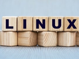 LINUX - word on wooden cubes on a gray background.