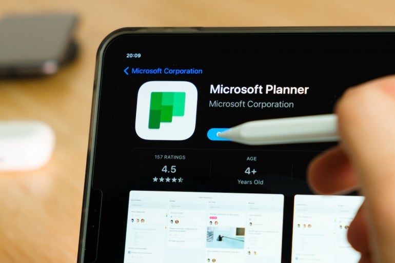 Microsoft Planner logo shown by apple pencil on the iPad Pro tablet screen. Man using application on the tablet. December 2020, San Francisco, USA.