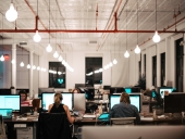 Office with people in front of computers.