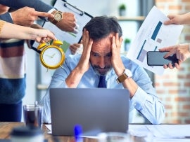 Group of business workers working together. Partners stressing one of them at the office