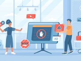 two people standing around a large monitor with ad blocking symbols floating around them