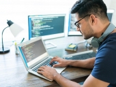 person coding on a laptop
