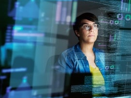 Cropped shot of a young computer programmer looking through data.