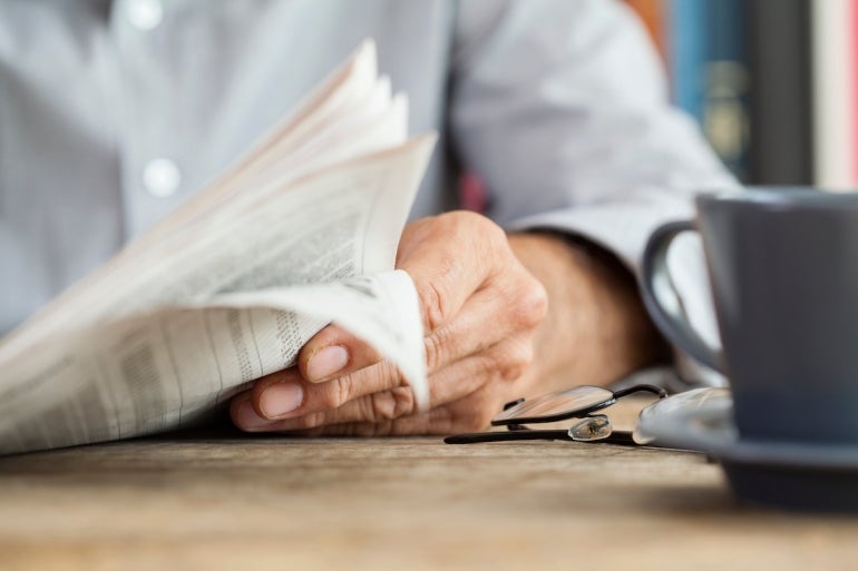 Man paper  speechmaking  connected  table