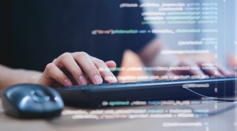 close up computer programmer man hand typing configuration on keyboard at laptop for input coding language to software for fix bug and defect of system in data center room , engineering and technology