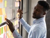 Man Managing a Project with Sticky Notes