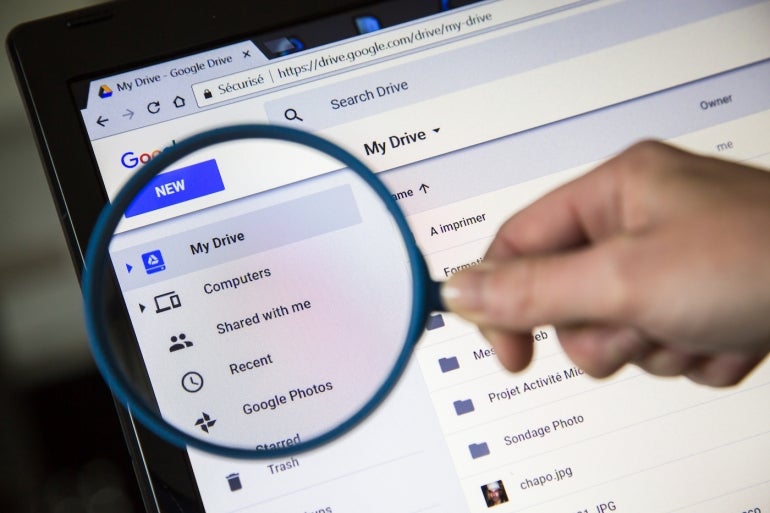 A magnifying glass held over the Google Drive toolbar.