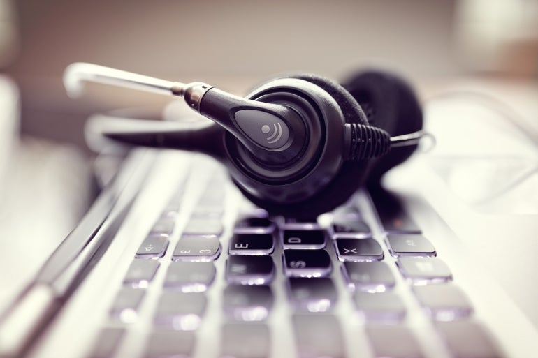 Headset on a laptop computer keyboard.