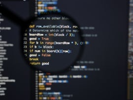 Lines of Python code visible under magnifying lens.