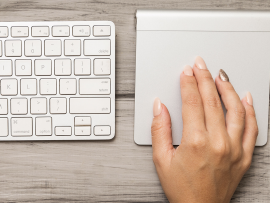 A hand demonstrating the Magic Trackpad.