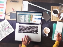 data scientist working on a laptop with a spreadsheet open