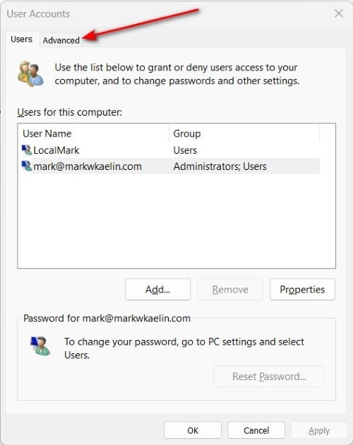 A red arrow pointing to the Advanced tab in the User Accounts menu in Windows 11