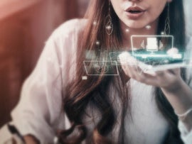 A businesswoman using voice control on an iPhone.