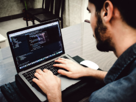 A Powershell user working on a laptop.