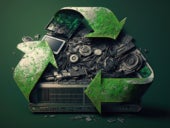 An image of a recycling logo with a pile of e-waste in the middle.