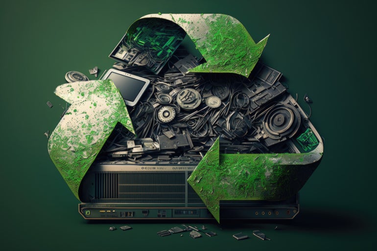 An image of a recycling logo with a pile of e-waste in the middle.