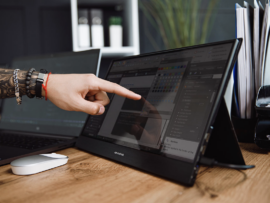 A user with the Desklab Portable 4K Touchscreen Monitor.