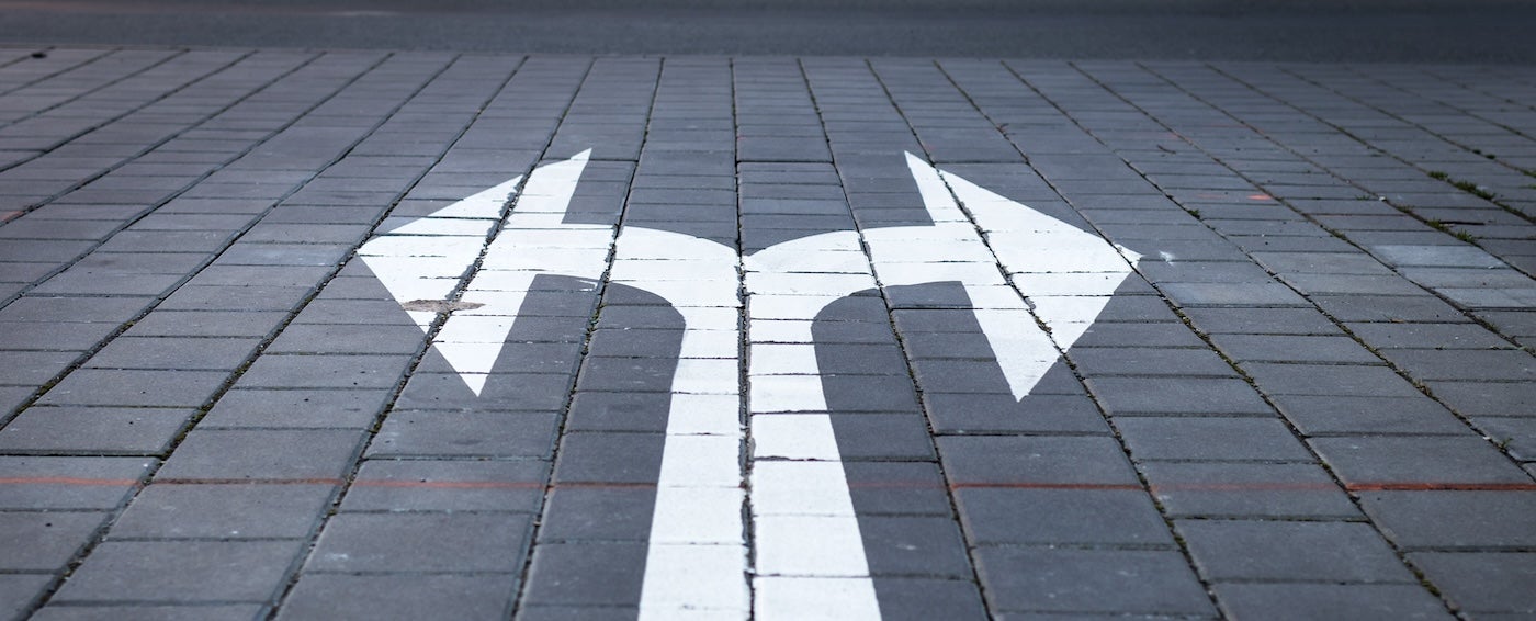 Image of 2 arrows on a road.
