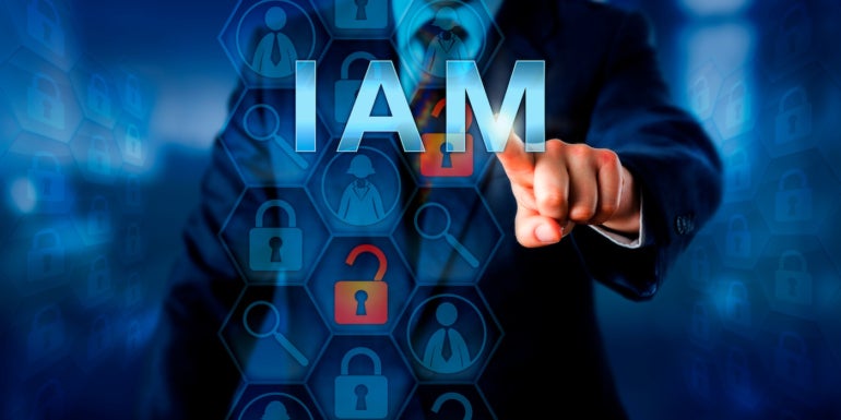 A business person tapping the word IAM.