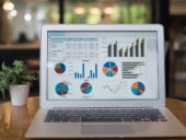 Accounting software featuring different graphs and charts on laptop display.