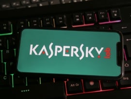 Closeup of mobile phone with logo lettering of kaspersky anti virus computer security software on keyboard.