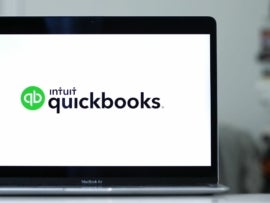 Laptop displaying the logo of Quickbooks accounting software program.