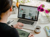 Woman looking at collection of images on a laptop.