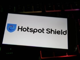 View on mobile phone screen with logo lettering of vpn service hotspot shield company on computer keyboard.