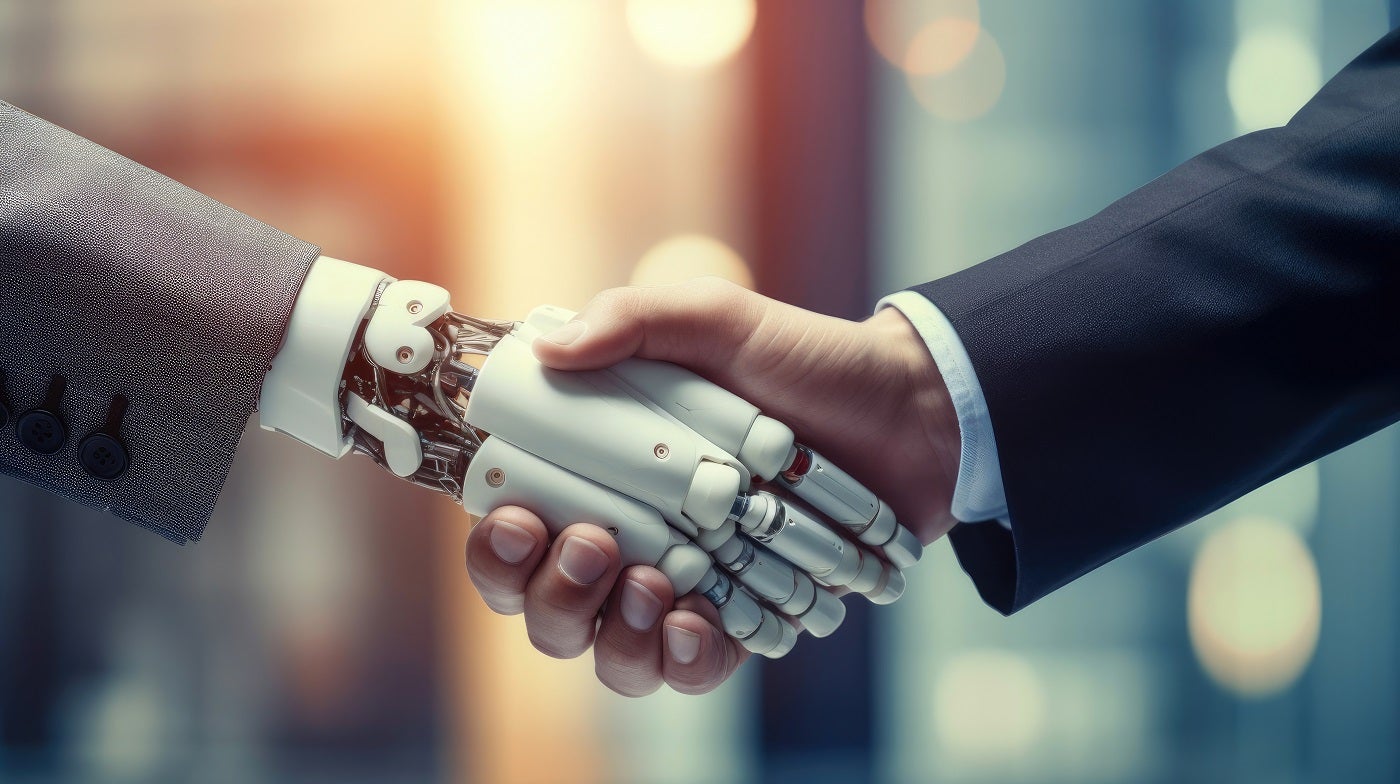 A handshake between a human hand and a robotic hand.