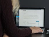 Woman working with WordPress on a laptop.