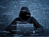 Cluster of characters forming a silhouette of a hacker using a laptop.