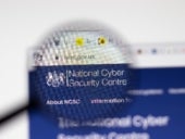 NCSC National Cyber Security Centre website page on display screen with magnifying glass.