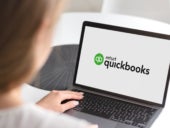 Notebook with Intuit Quickbooks logo on display.