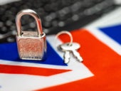 United Kingdom cyber security concept. Padlock on computer keyboard and UK flag.