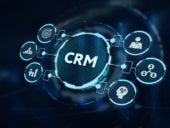 CRM inscription surrounded by related icons on a virtual screen.
