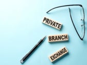 Private Branch Exchange concept on wooden block on blue background.