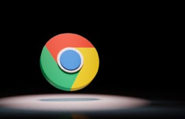 Google Chrome logo spotlighted on black background.