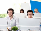 Call center employees working in an open office floor plan.