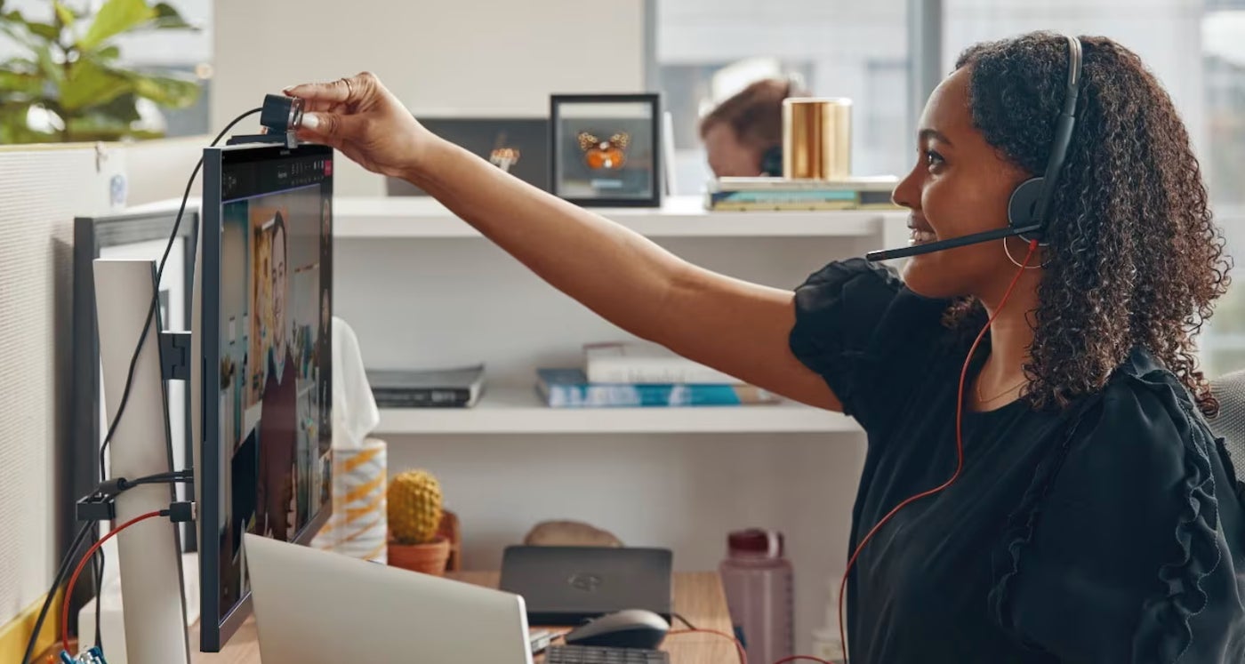 A woman using the Poly Blackwire 3200 headset.