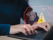 Man using a laptop with virtual AI related images and a warning icon.