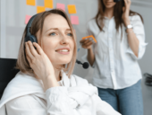 A call center agent talking to someone through a headset.