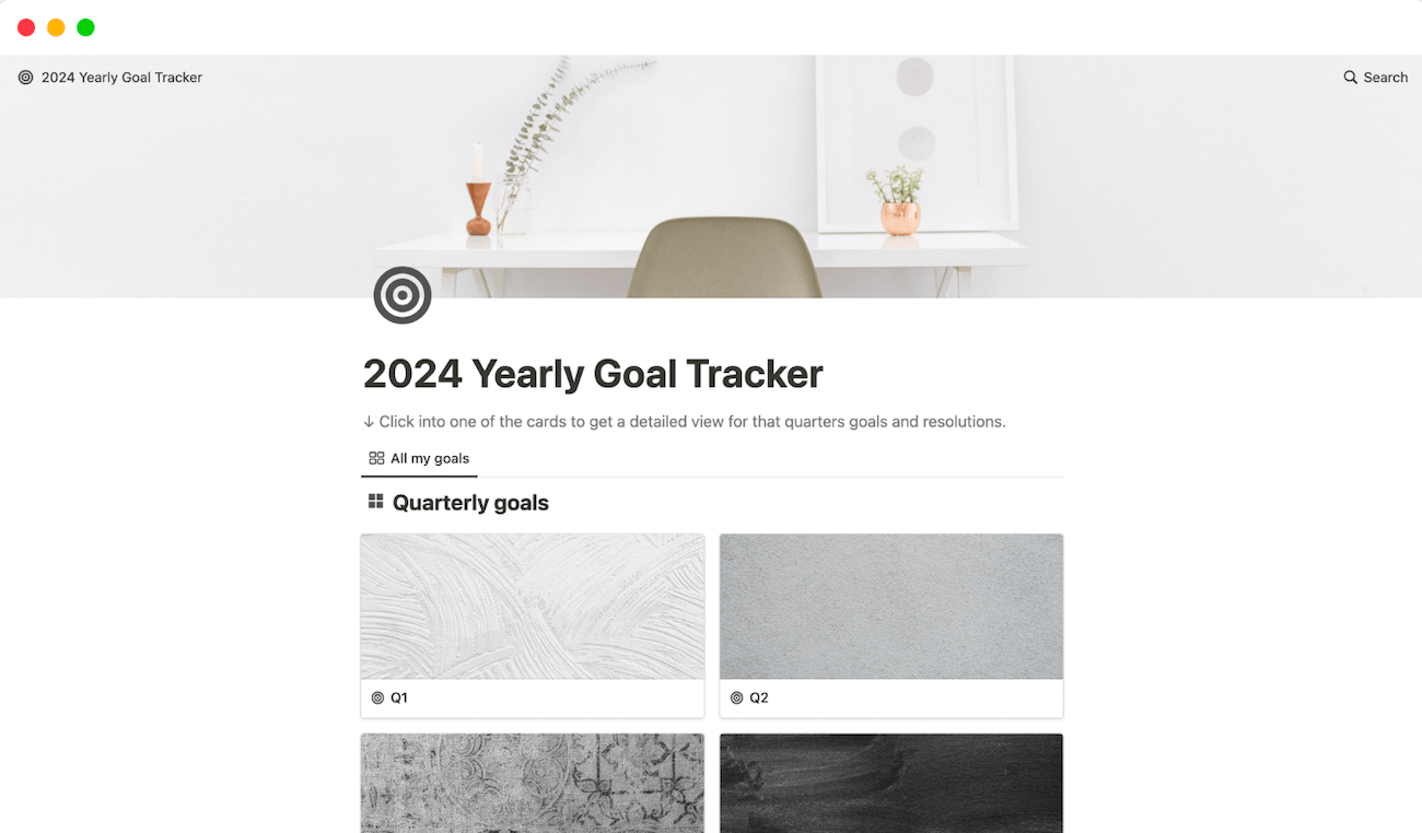 A 2024 yearly goal tracker with cards for each quarter and an image of a desk at the top of the page.