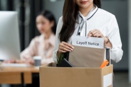 Closeup woman holding brown paper envelope in a Cardboard box standing in office.